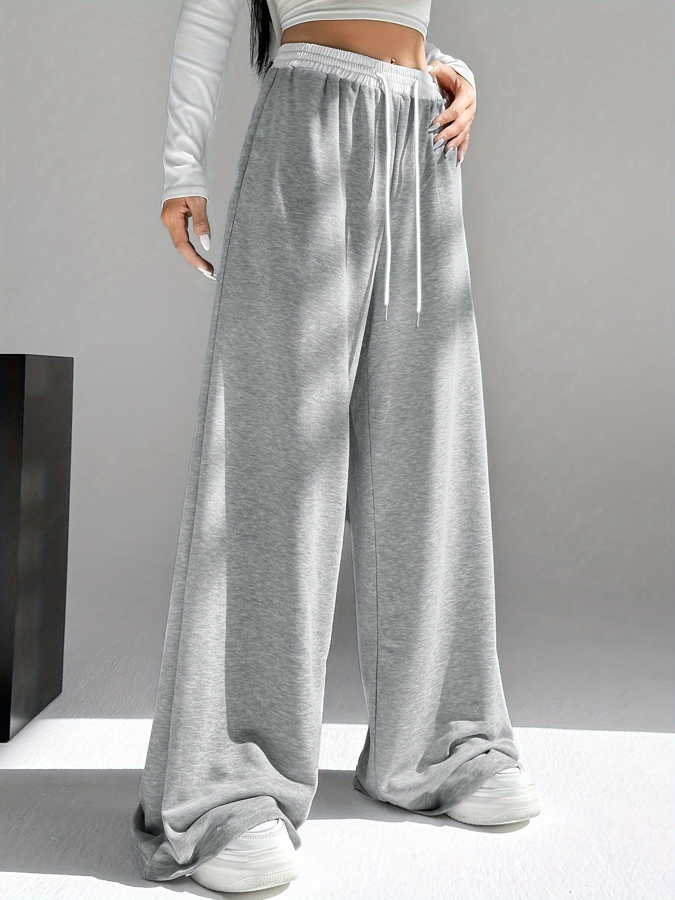 High waist wide leg drawstring pants in contrasting colors for women's spring and fall attire.