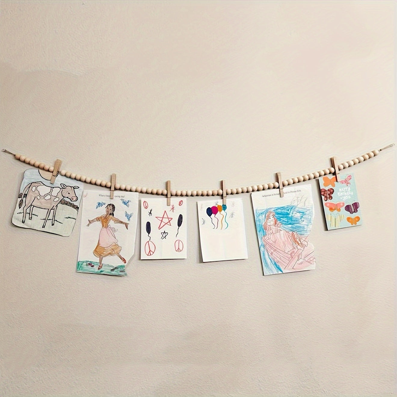 Wooden photo display stand with hanging wooden bead and clip, ideal for room or kindergarten decor and art display.