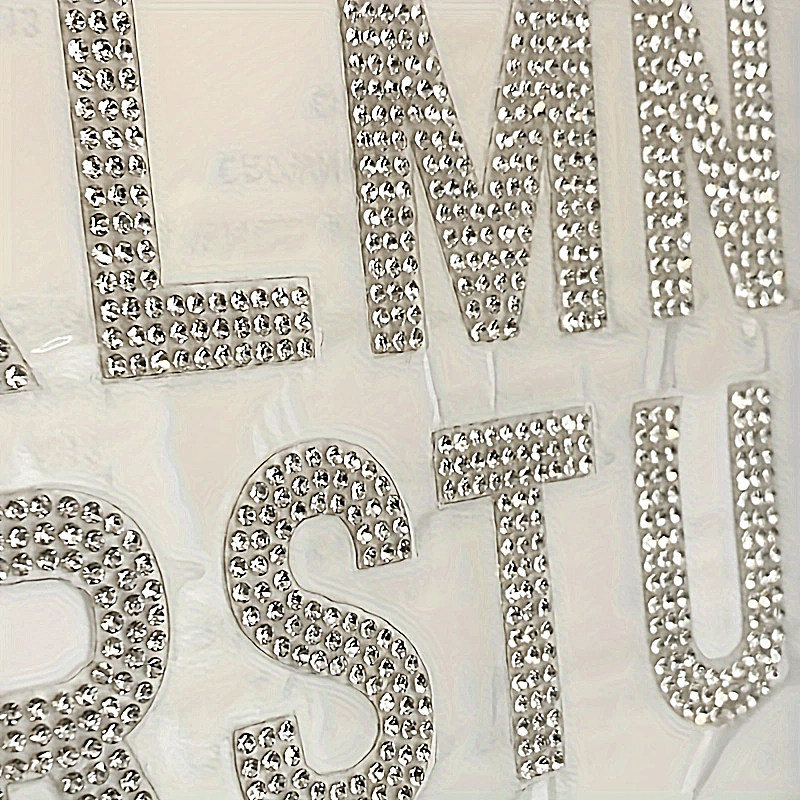 26 pieces of self-adhesive silvery rhinestone letters from A to Z, backed with iron and made of glass. Perfect for DIY projects on clothing, shoes, hats, car decorations, and other hobby crafting activities. Mix and match to personalize your items with a