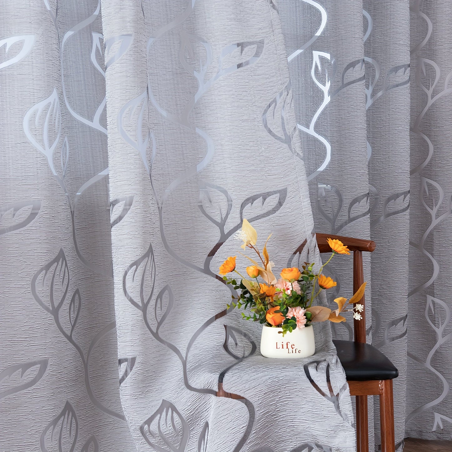 Elegant and contemporary gray floral sheer curtain with a rod pocket design, perfect for enhancing the decor of your living room, bedroom, or home.