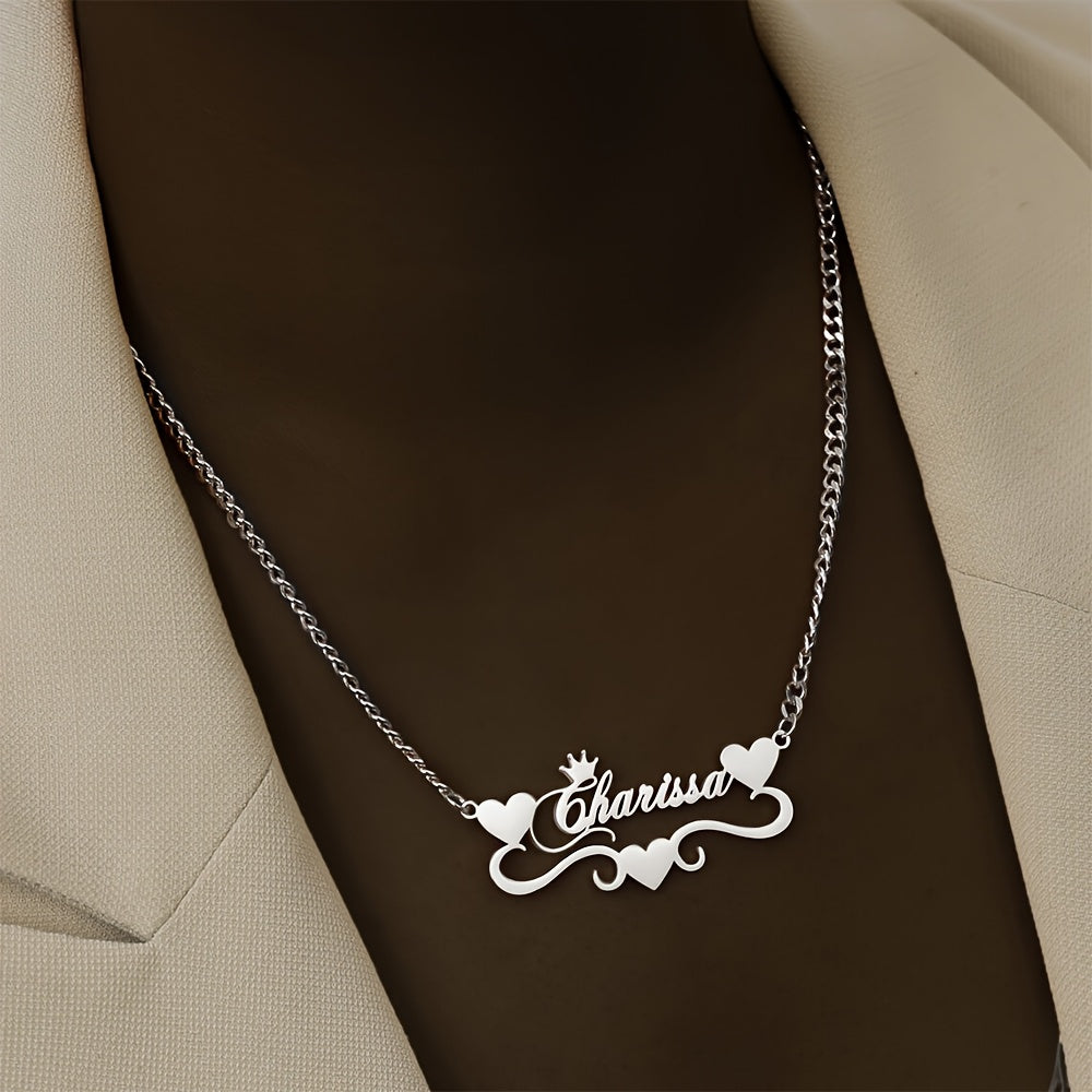 A single elegant custom 4MM Cuban link chain necklace with personalized name pendant, featuring a stainless steel heart ribbon plaque. This fashion crown jewelry for women is a versatile daily accessory suitable for all-season wear.