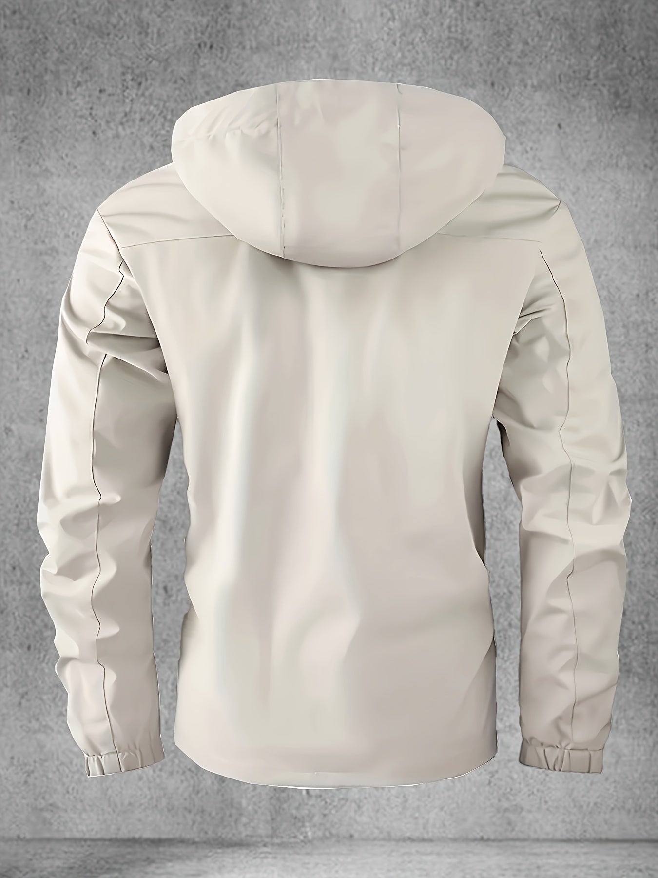 Hooded softshell jacket with multiple pockets for spring and autumn outdoor activities.