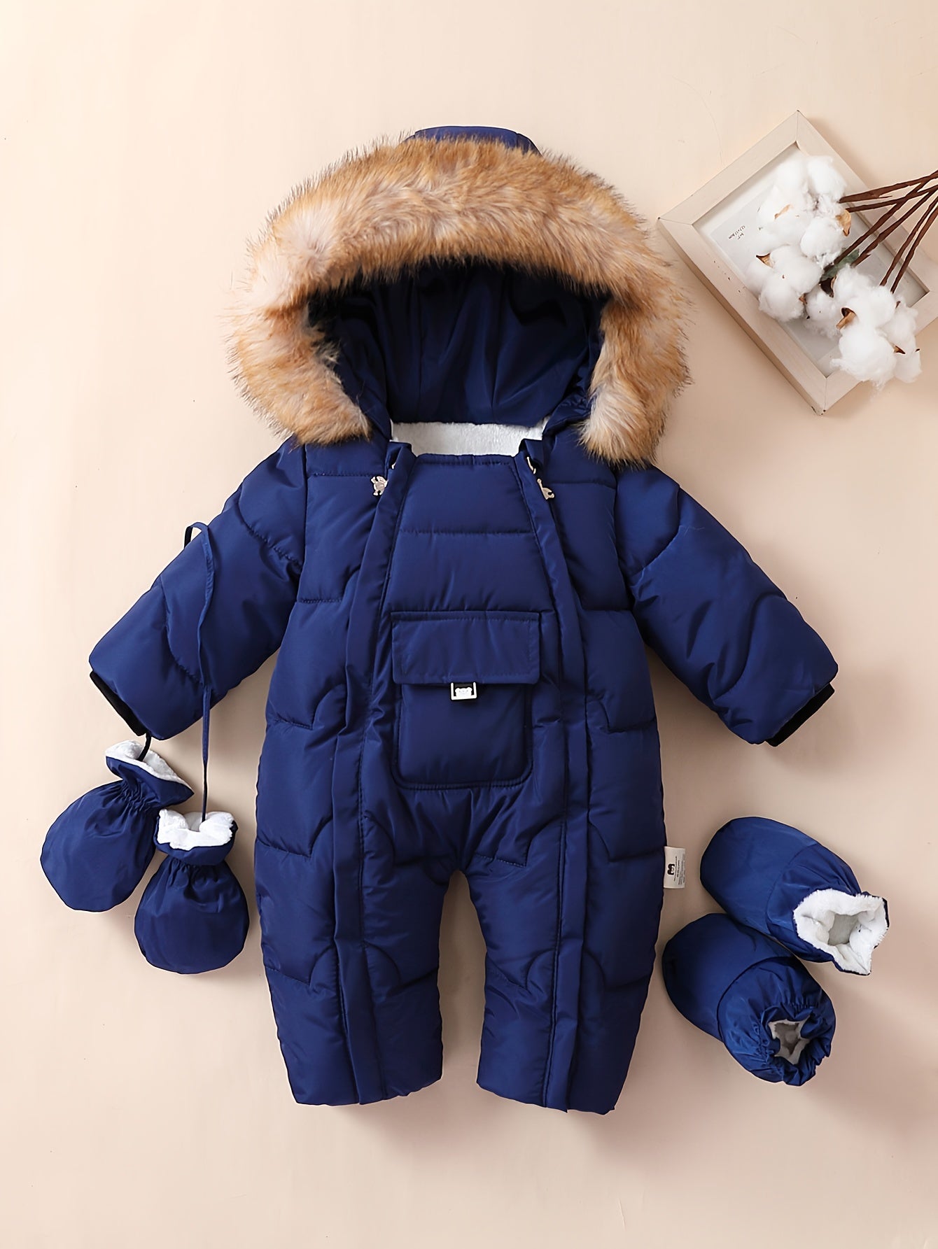 Baby boys jumpsuit with hood, faux fur trim, fleece lining, mittens, and booties for outdoor winter wear.