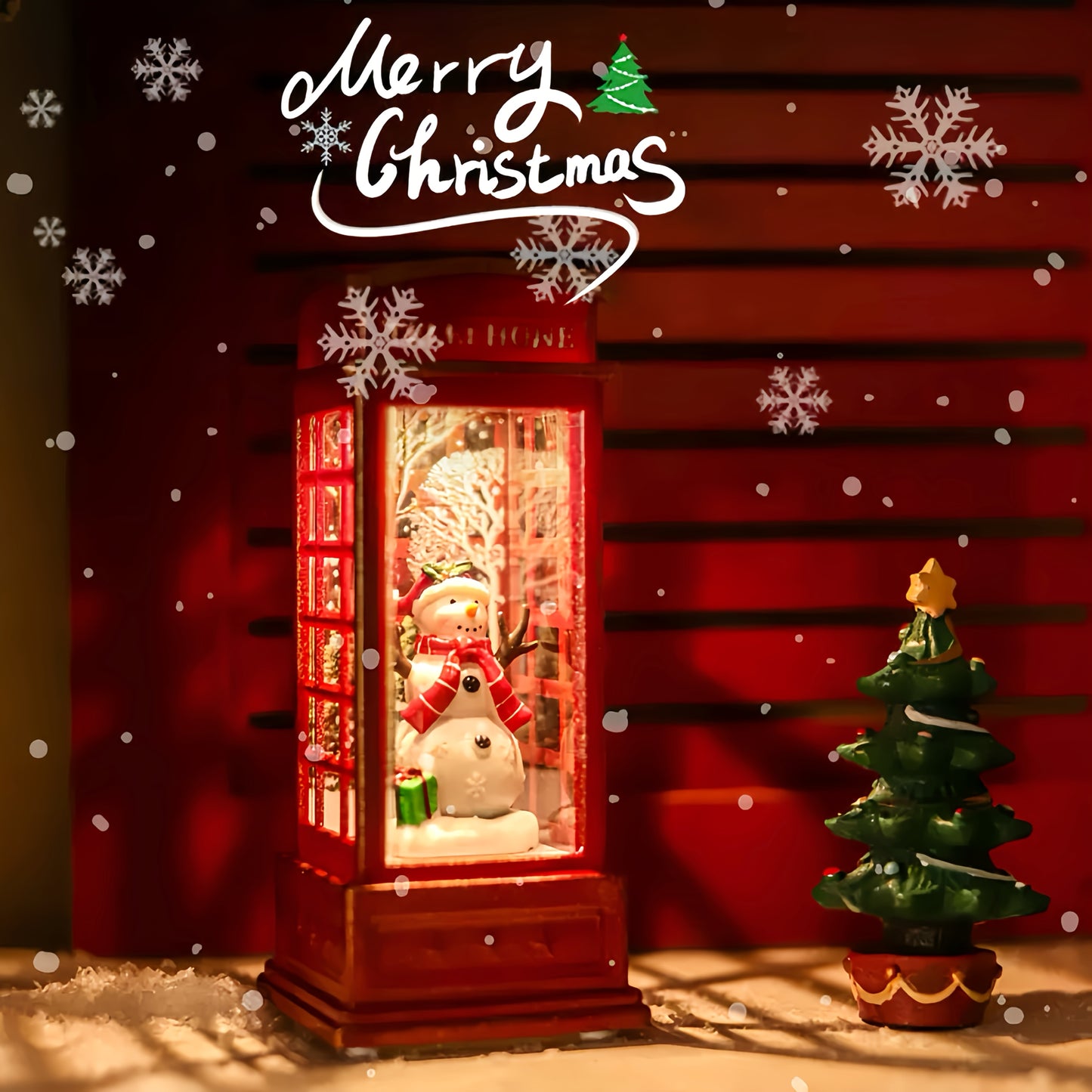 Festive Christmas phone booth decoration featuring Santa, snowman, and tree scenes. Battery-operated with illuminated red cabinet for holiday display.