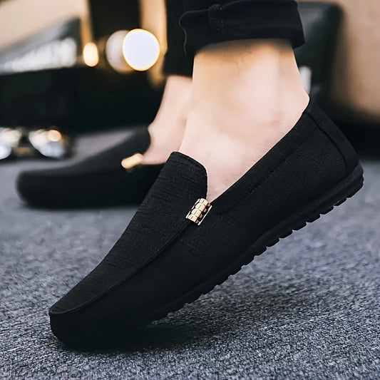 Men's black canvas loafers with metal decor, round toe, comfortable insole, suitable for casual and outdoor wear.