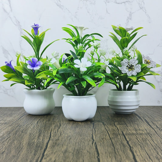 Set of 3 mini artificial potted plants with white pots for home decor. Perfect for living room, office desk, or festive tabletop decor for various occasions.