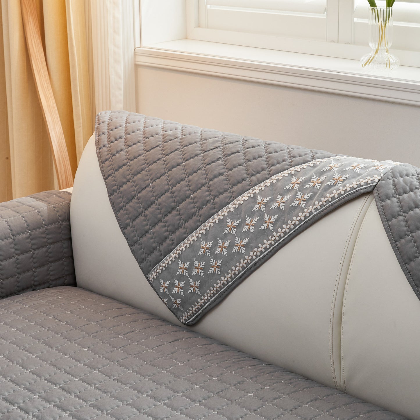 Waffle quilting sofa cover with snowflake lace decor and anti-slip backing.