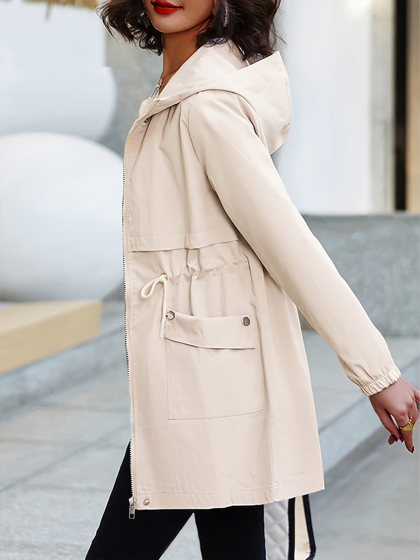 Plus size beige trench coat with hood in casual polyester, knee-length with long sleeves. Features zip-up closure, adjustable drawstring waist, and pockets.