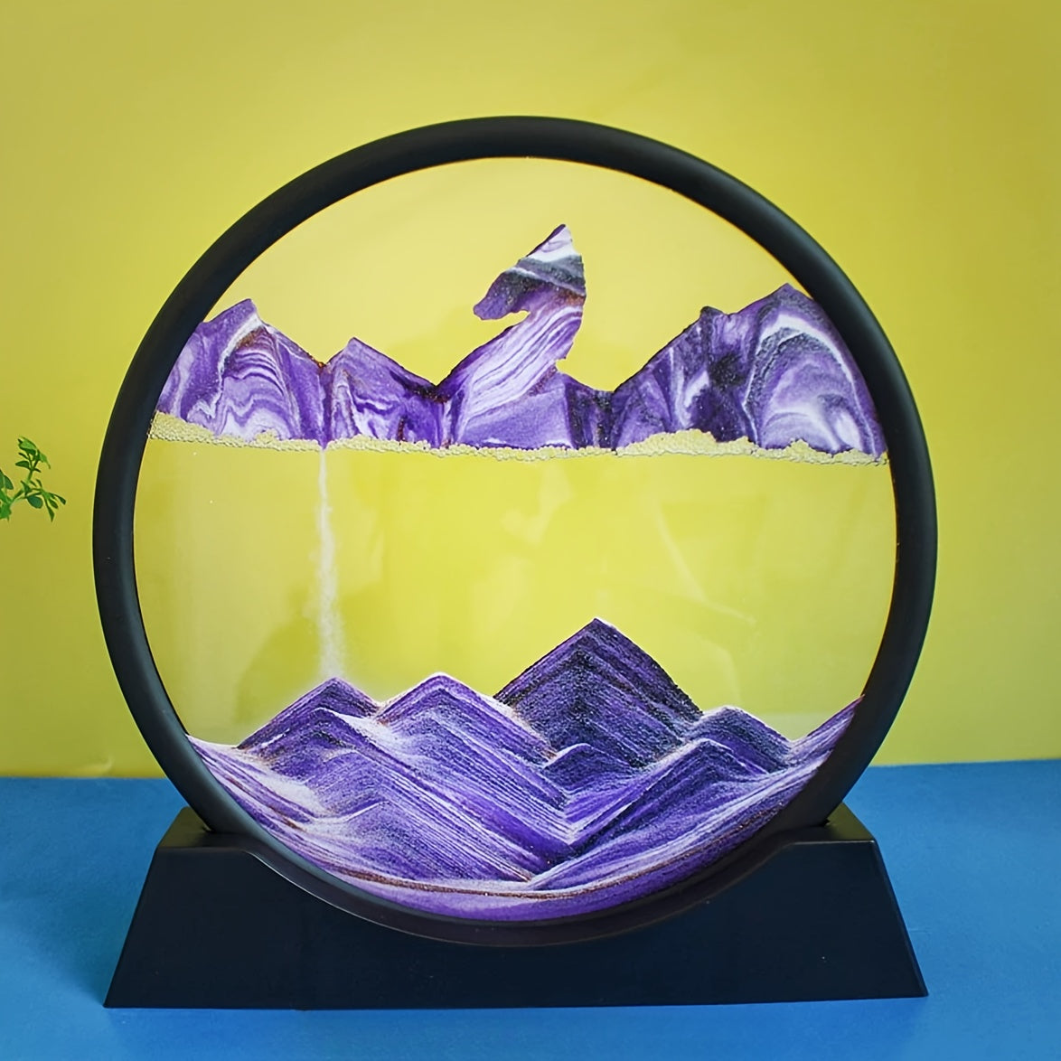 Large round glass frame with flowing sand creates a 3D deep sea scene as a relaxing home and office decoration.