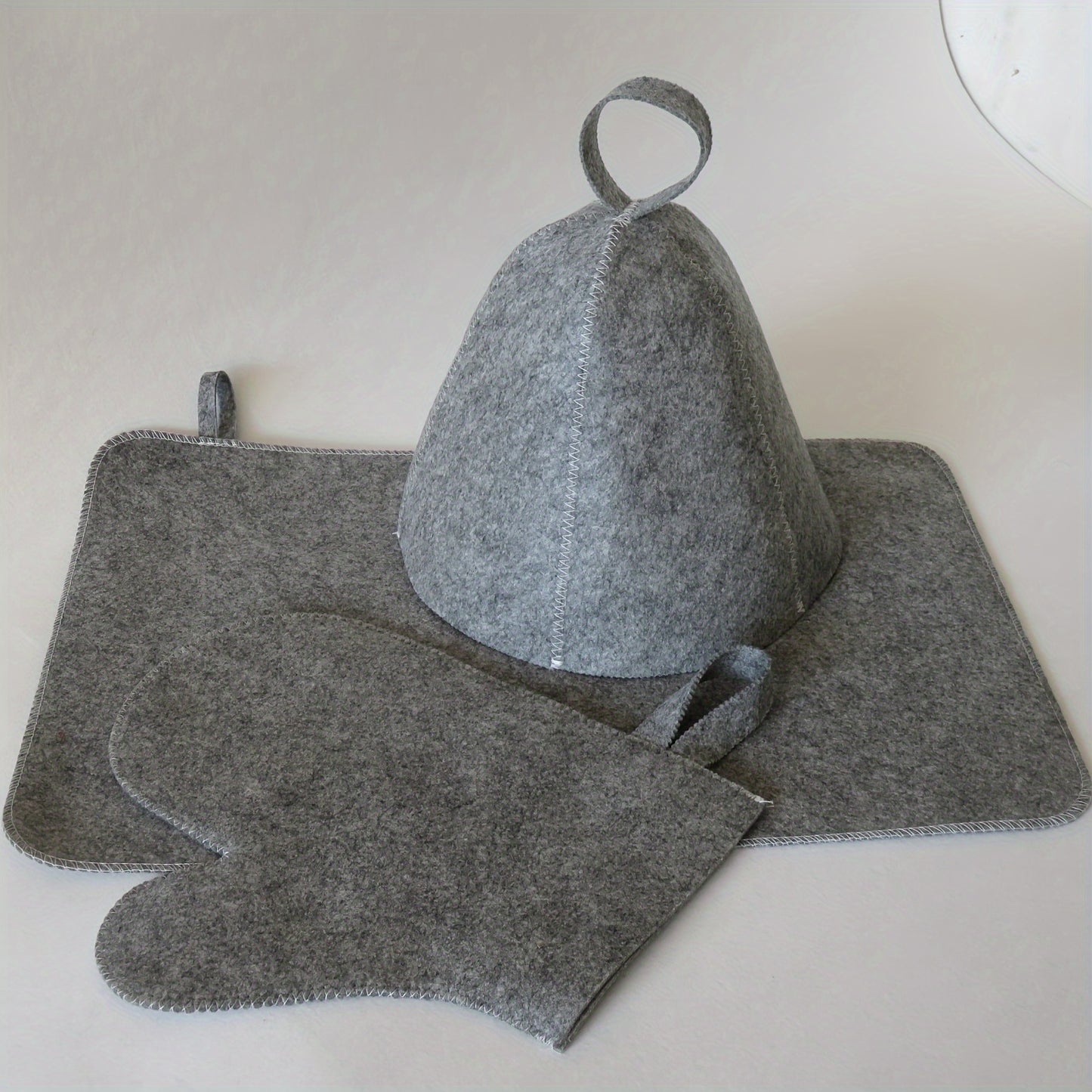 100% felted sauna accessory set includes thermal insulating and absorbent mat, cap, and mitt.