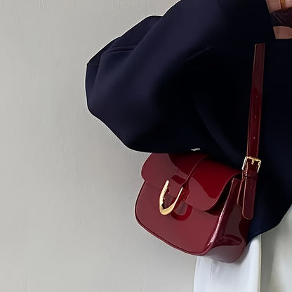 Elegant red baguette bag for women with detachable strap, golden-tone hardware, and glossy finish.