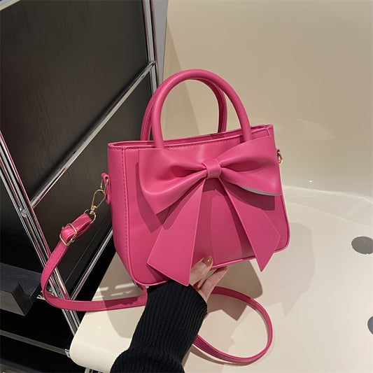 Faux leather crossbody bag with bow embellishment, adjustable strap, zipper closure, solid color, edge paint, animal theme from Baigou Production Area.