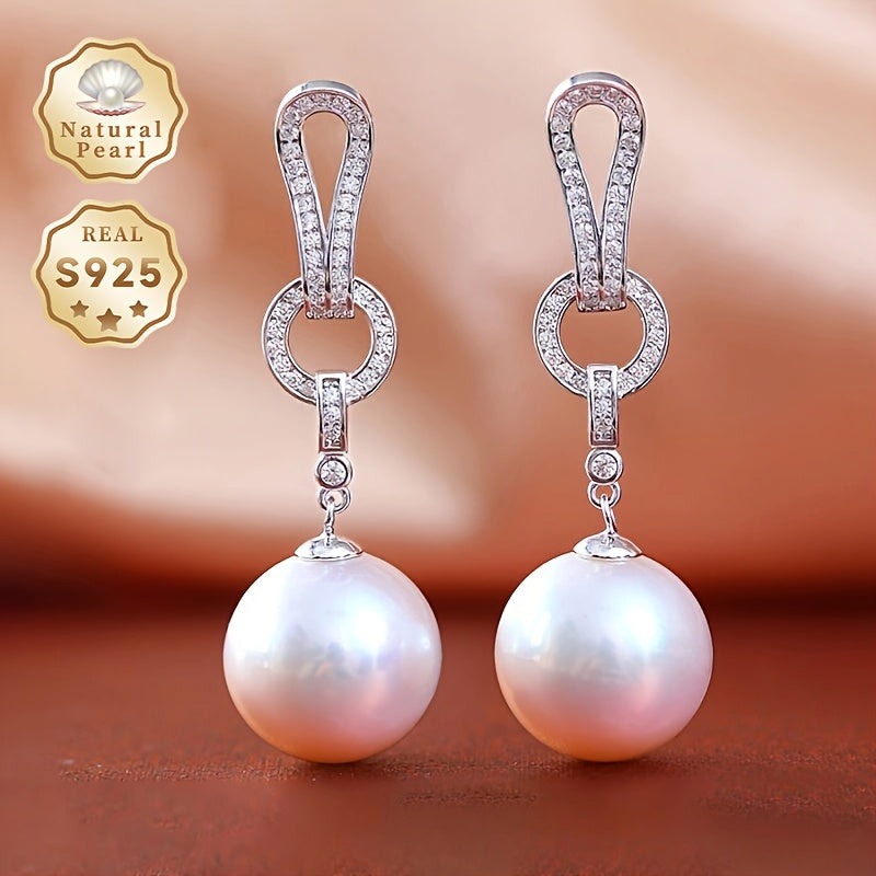 Add a touch of elegance to your collection with these must-have Pearl Dangling Earrings. Crafted with 13-14mm round natural freshwater pearls, these fashionable long earrings are made of S925 silver. Each pair is unique and features varying shapes and