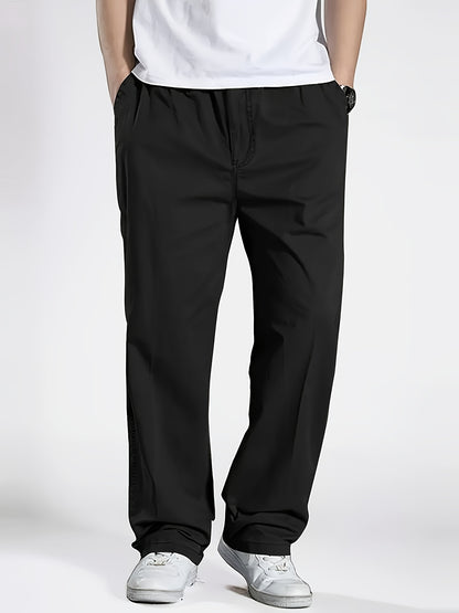 Men's slim fit casual pants with pockets, mid-rise drawstring waist, and breathable polyester fabric for spring/fall wear.