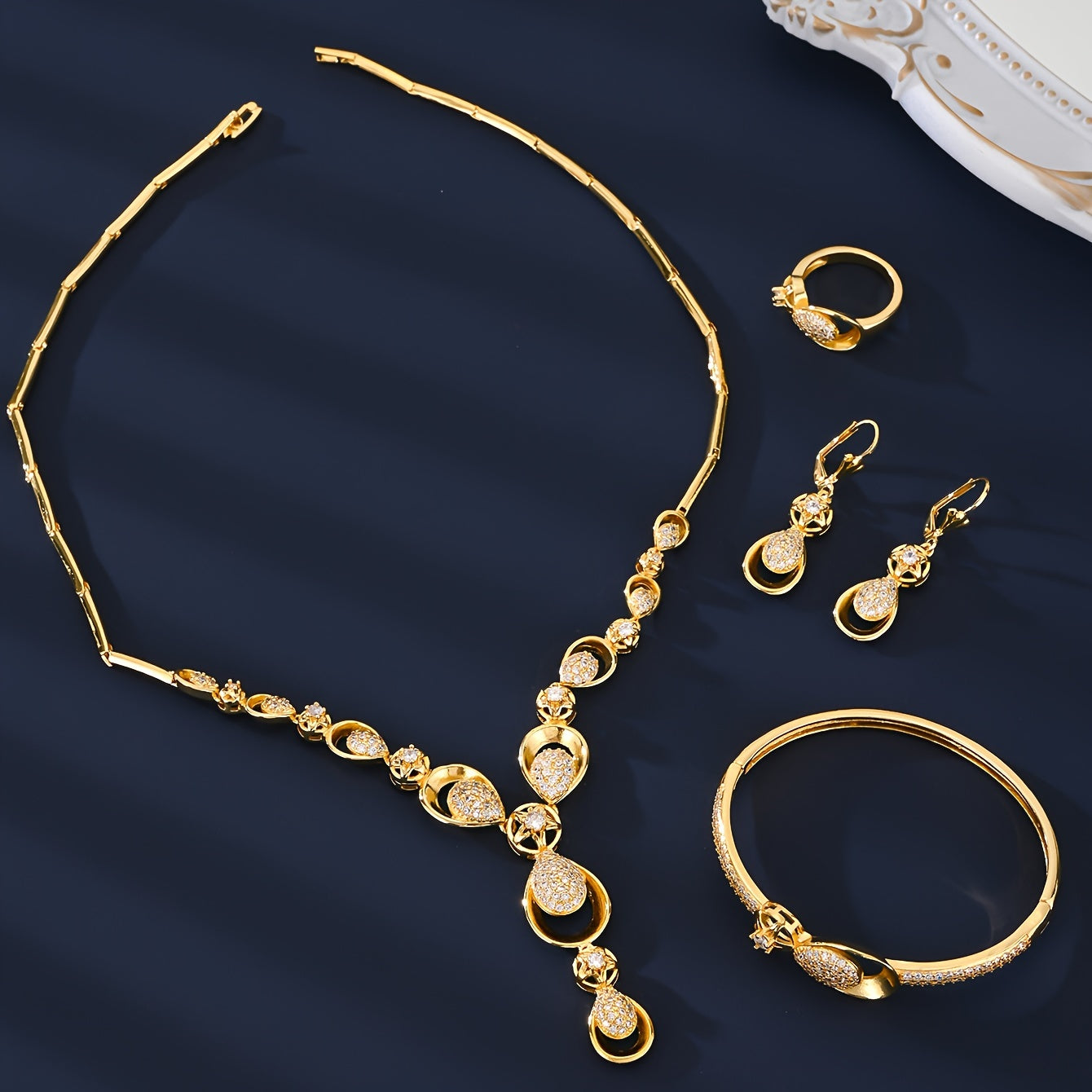 Exquisite 5-Piece Jewelry Set featuring 18K Gold Plating and Sparkling Zirconia Stones. This Set includes a Copper-Based Necklace, Earrings, Bracelet, and Ring perfect for Everyday Wear, Special Occasions, and as Gifts for Valentine's Day.