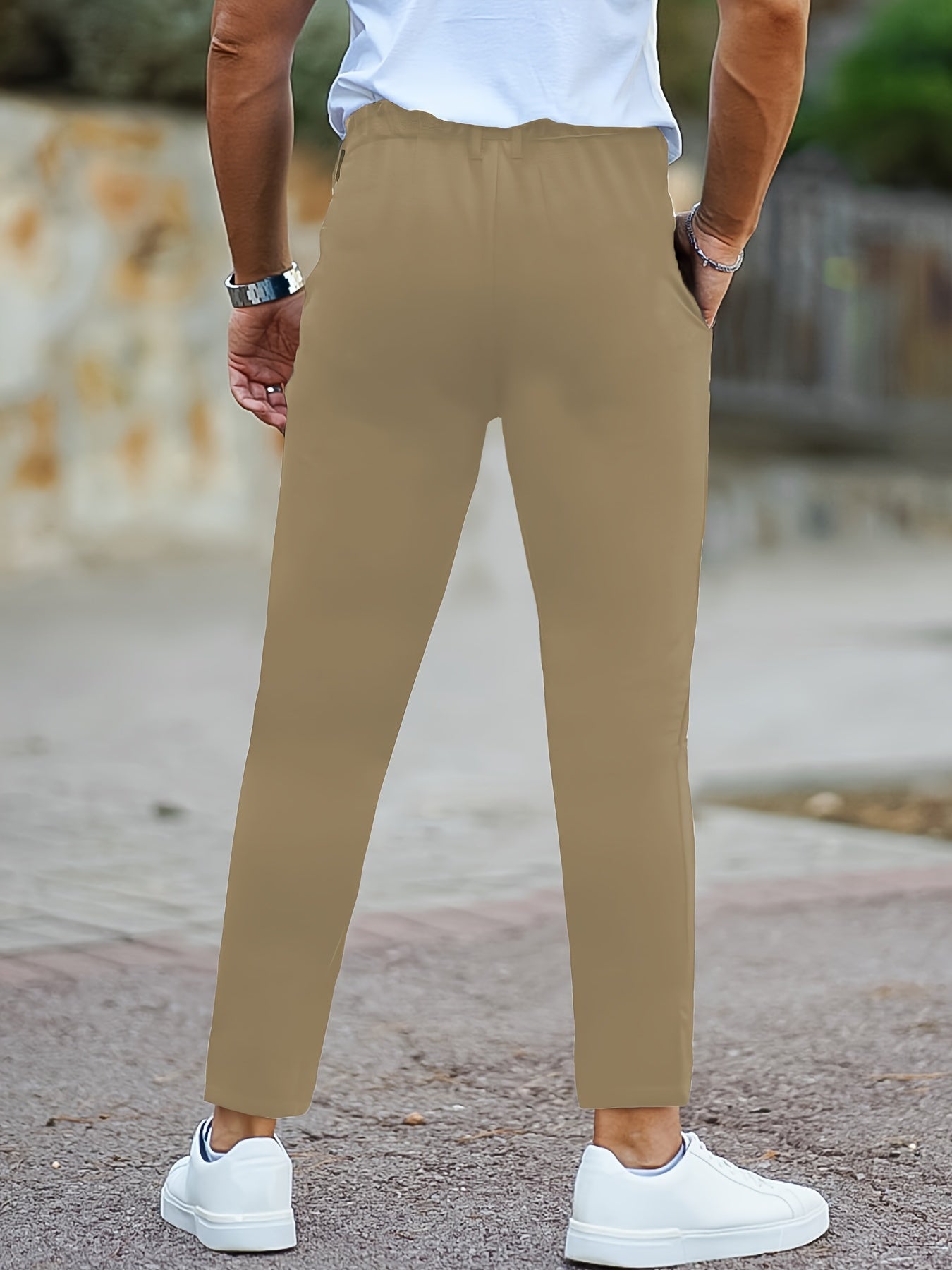 Skinny fit men's trousers made of polyester knit fabric with medium stretch, zipper detail, and suitable for all seasons.