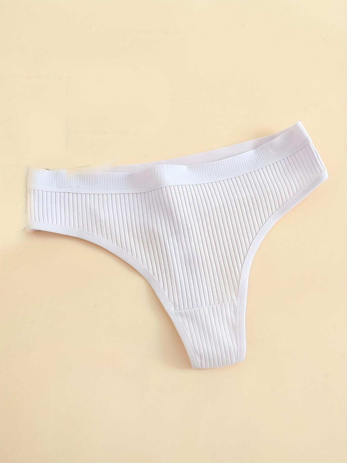 6-Pack of comfortable seamless cotton thongs for women, v-string style with low waist, solid color, simple design, and non-see-through fabric.