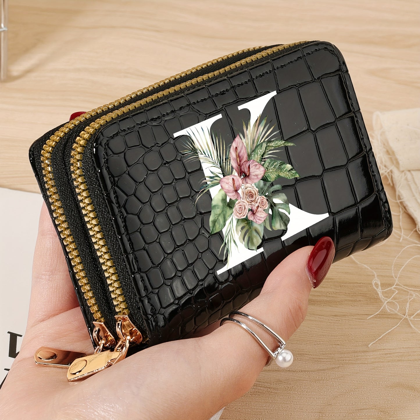 Women's credit card wallet with elegant floral letter print in black & white. Features large capacity, dual zipper, crocodile texture PU, lightweight design with nylon lining for everyday