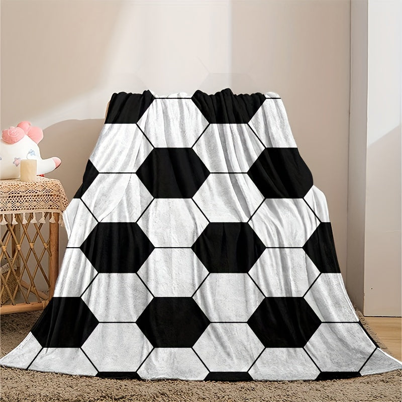 Soft and cozy football-themed blanket for kids made of flannel, featuring a hexagonal black and white soccer ball pattern. Perfect for bed, sofa, travel, and camping. Ultra-soft, lightweight, and warm. Machine washable. Ideal for both bed and sofa.