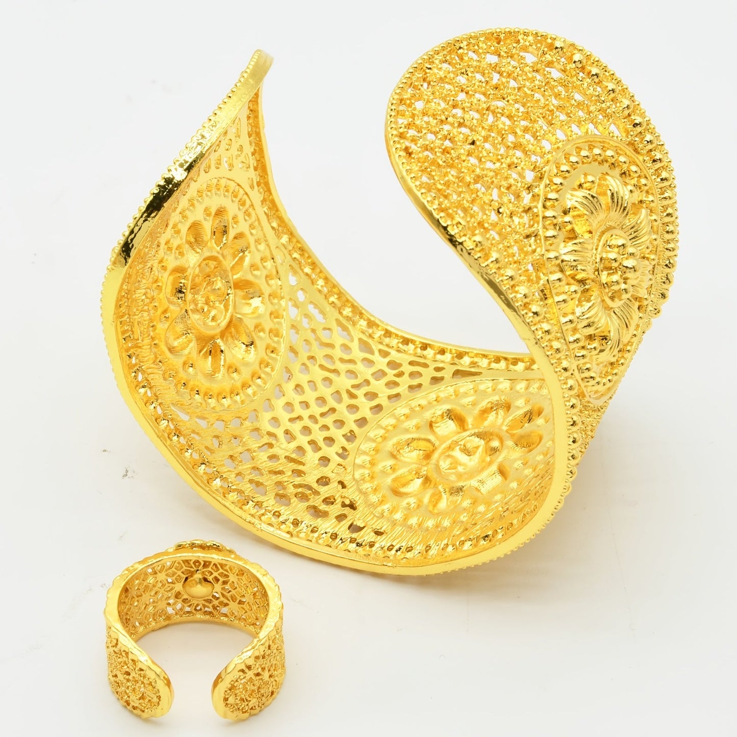 Add a touch of elegance to your outfit with this stunning set featuring a 24K golden plated zinc alloy bangle and ring. The floral design is adjustable, making it perfect for women to wear daily or for special occasions such as parties, engagements