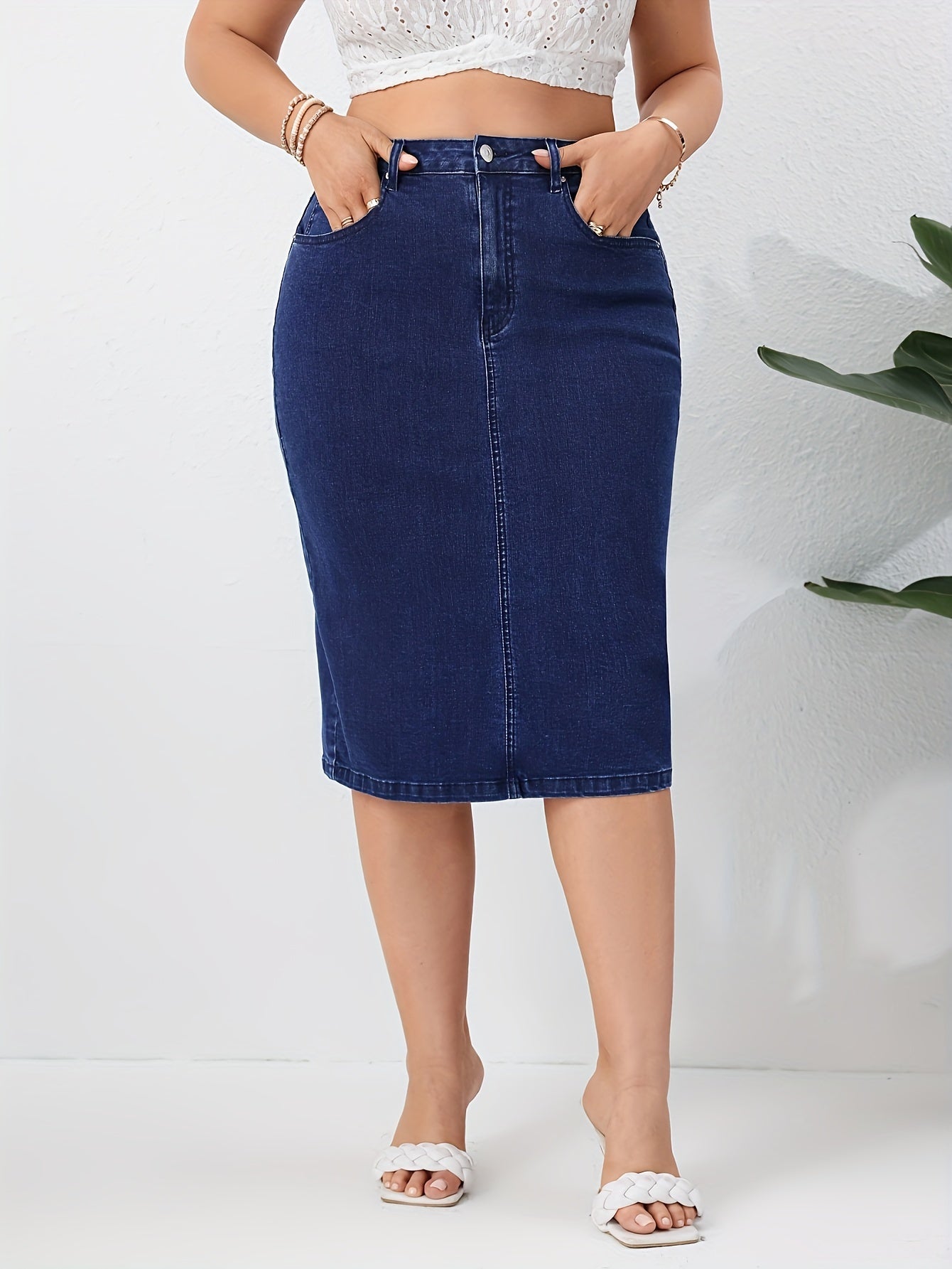 Blue washed high rise plus size bodycon denim skirt with slash pockets for women.