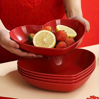 Heart-shaped plastic serving saucers in red for special occasions.