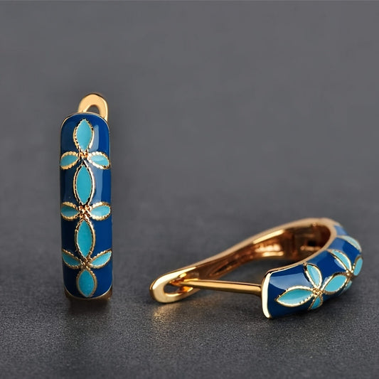 Vintage inspired luxury court style hoop earrings with beautiful blue enamel flower design and gold bordered copper hoops.