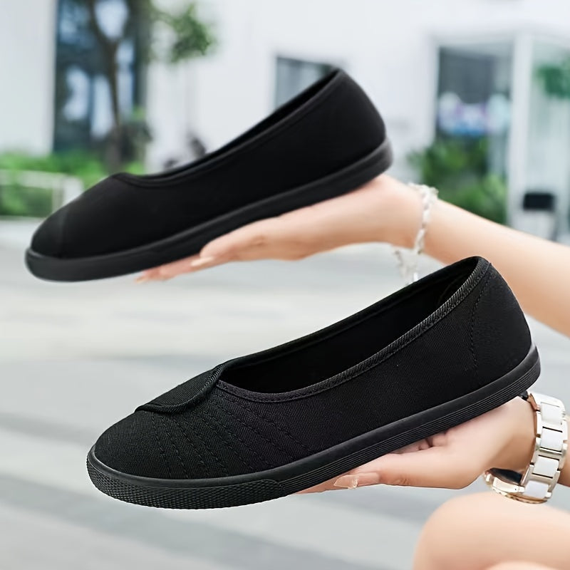 Women's white slip-on sneakers with breathable fabric upper, rubber sole, round toe, and sporty design.