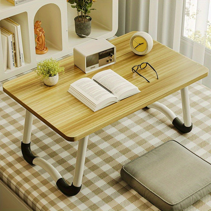 Foldable laptop desk with sturdy material and spacious desktop, suitable for student dorms.