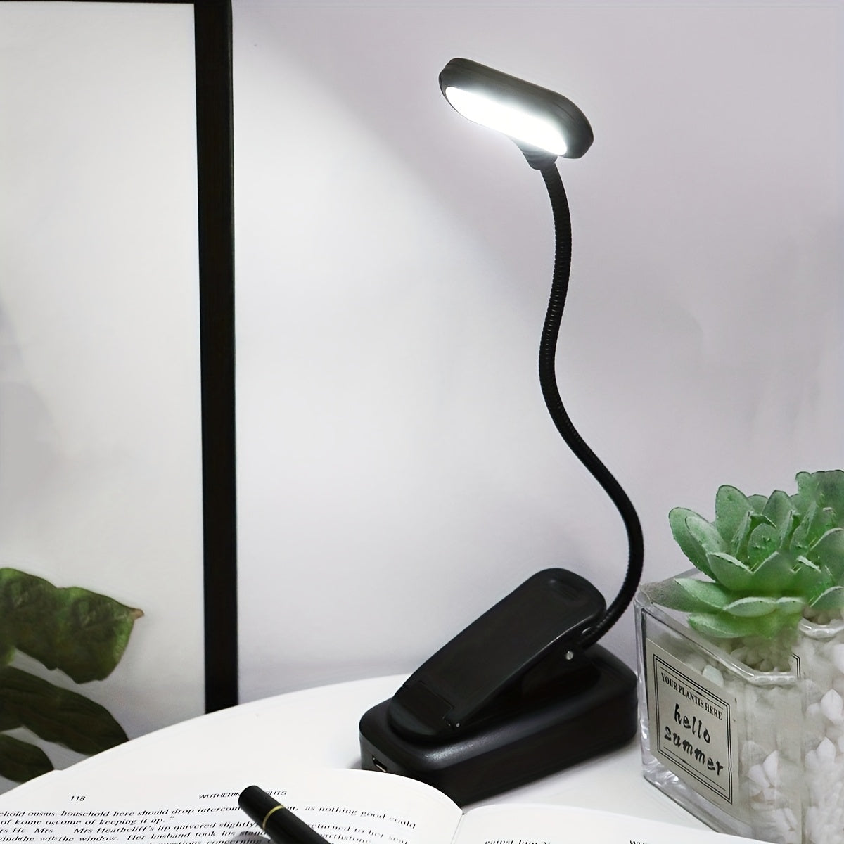 Portable battery-powered clip-on book light for reading that can also be used as a small table lamp or night light for room decor.