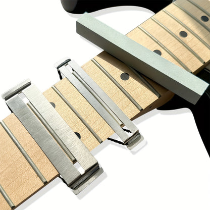 Guitar fretboard maintenance kit with metal protector and grey dressing stones for various string instruments.