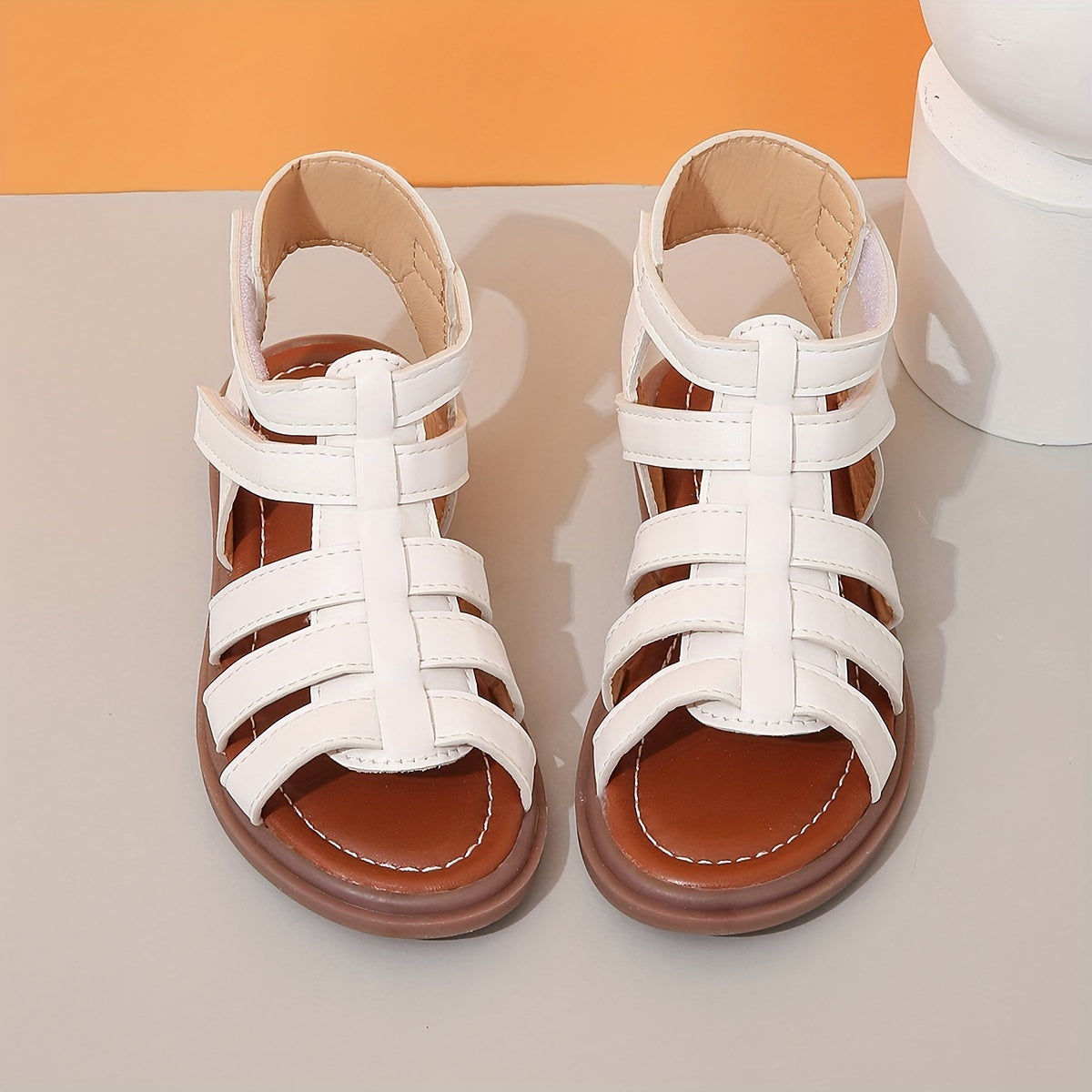 Ivory sandals for girls with brown sole, ideal for school and leisure activities.