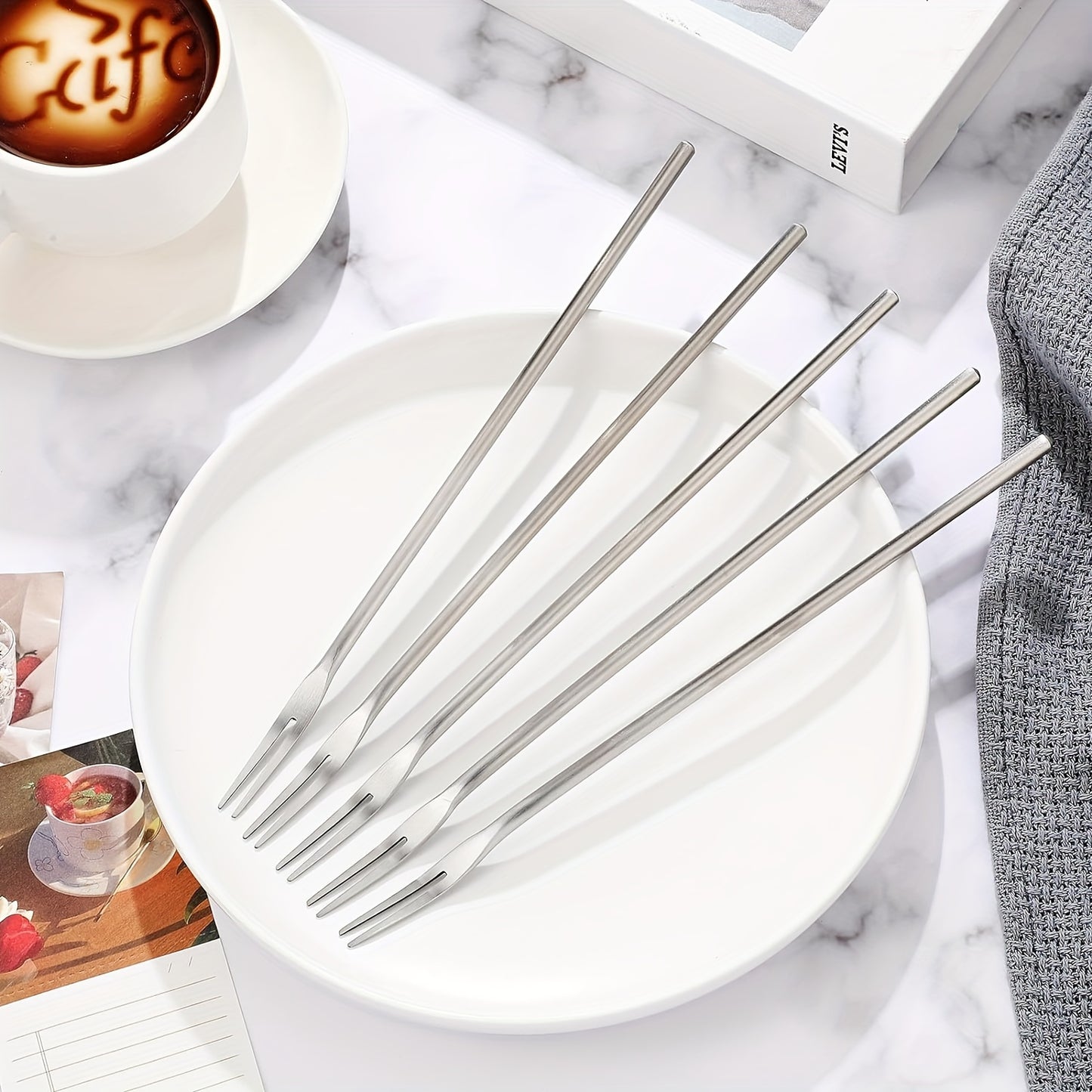 Stainless steel forks for serving and picking up pickles and olives.