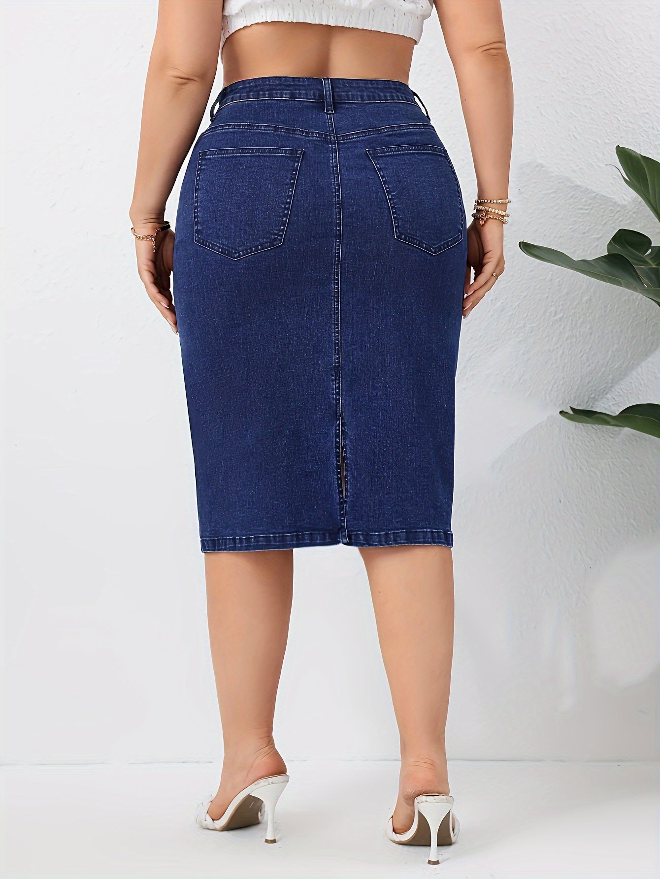 Blue washed high rise plus size bodycon denim skirt with slash pockets for women.