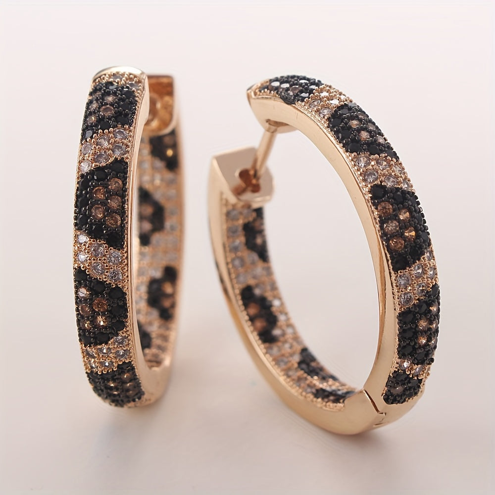 A set of stylish retro leopard print earrings with three rows of zirconia stones, crafted in copper for a bold and trendy look. These earrings are perfect for adding a touch of luxury to any outfit, and make a great gift for birthdays or just to treat