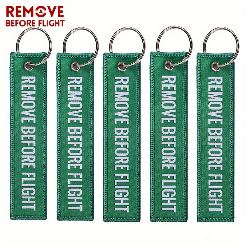 Bundle of 50 'Remove Before Flight' Woven Keychains made from sturdy polyester material - Ideal present for pilots and aviation fans, featuring the iconic phrase "REMOVE BEFORE FLIGHT