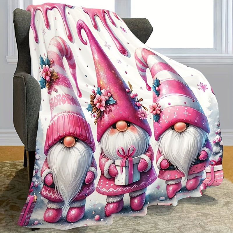 Soft, warm, and versatile flannel throw blanket featuring a cozy Christmas gnome and bell print. Perfect for snuggling on the couch, adding warmth to your office chair, staying cozy in bed, camping under the stars, or traveling in style. This all-season