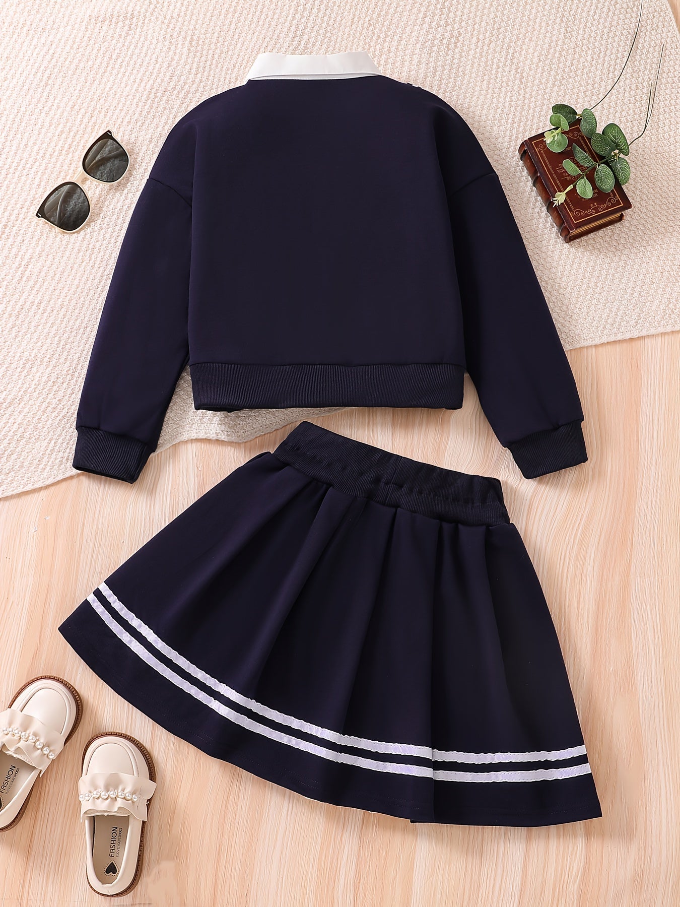 Young girl's campus style two-piece set: Short loose sweatshirt jacket + striped pleated skirt with tie.