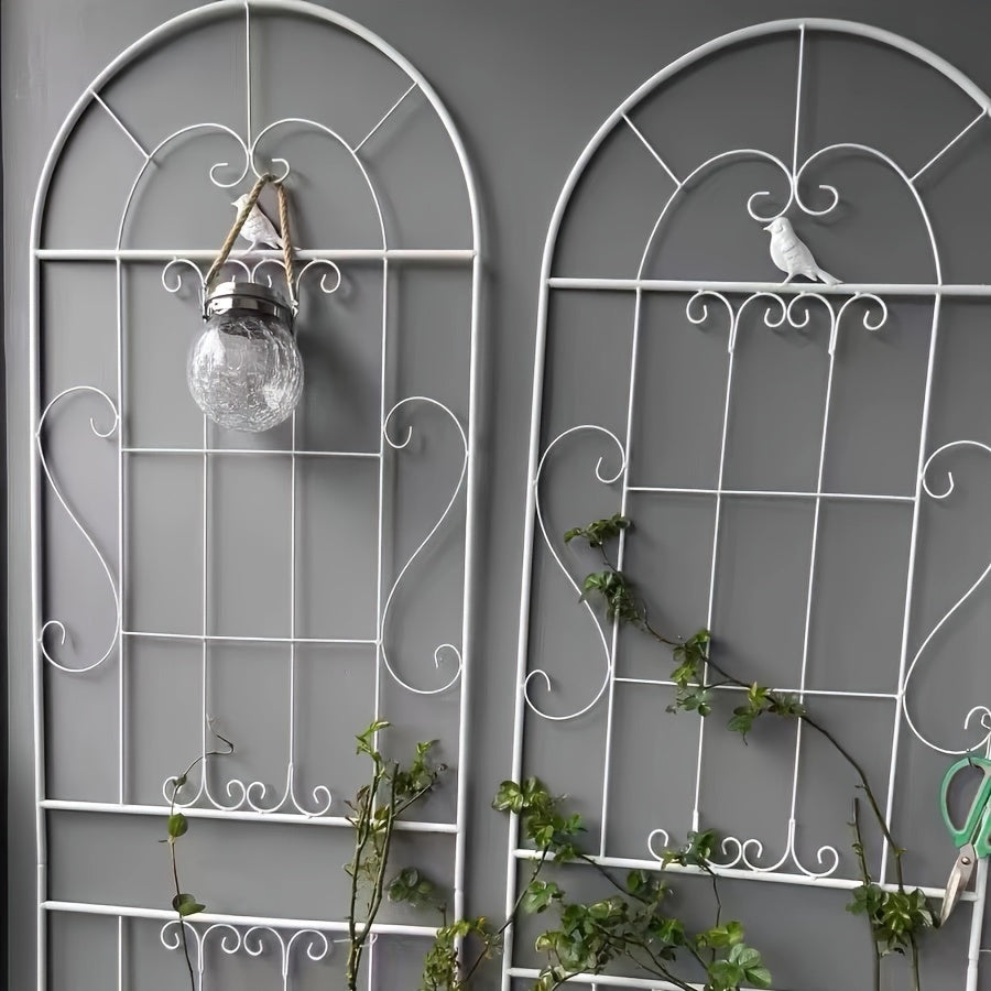 Outdoor iron trellis fence for climbing plants and flowers, ideal for decorating gardens.