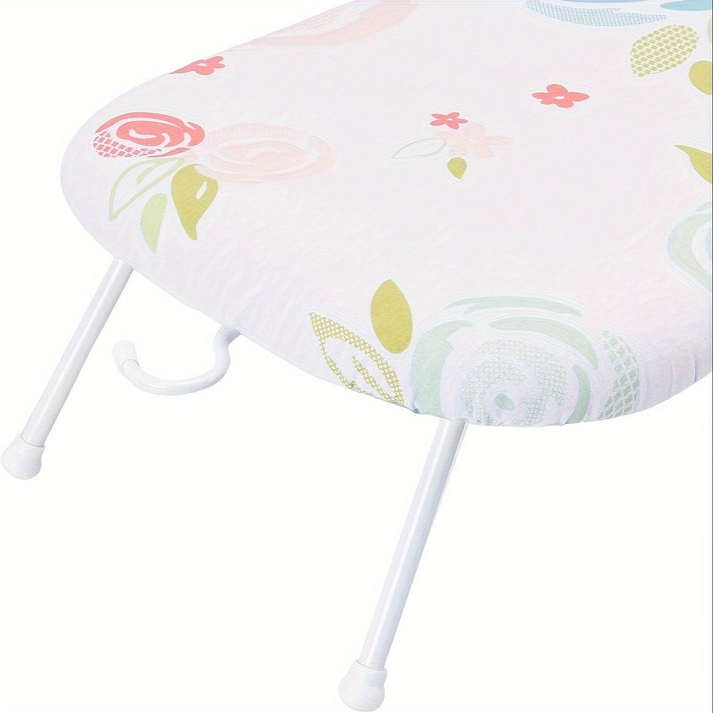 This foldable ironing board features a floral pattern design and is made of thick, high-temperature resistant material. It has a space-saving design with a hanging option, and comes in white with colorful flowers. Measuring 58.42cm x 35.56cm, this