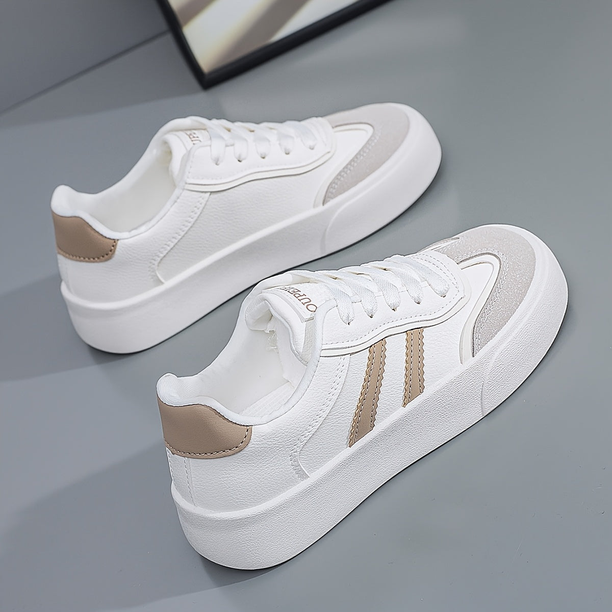 Women's lightweight white sneakers with beige accents are comfortable all-season footwear with a trendy classic design.