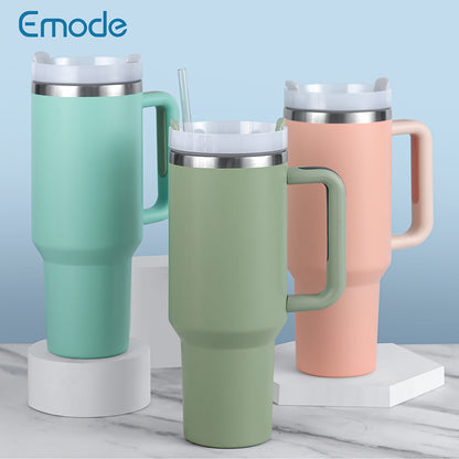 Stainless steel tumbler with lid and handle, ideal for summer drinks.