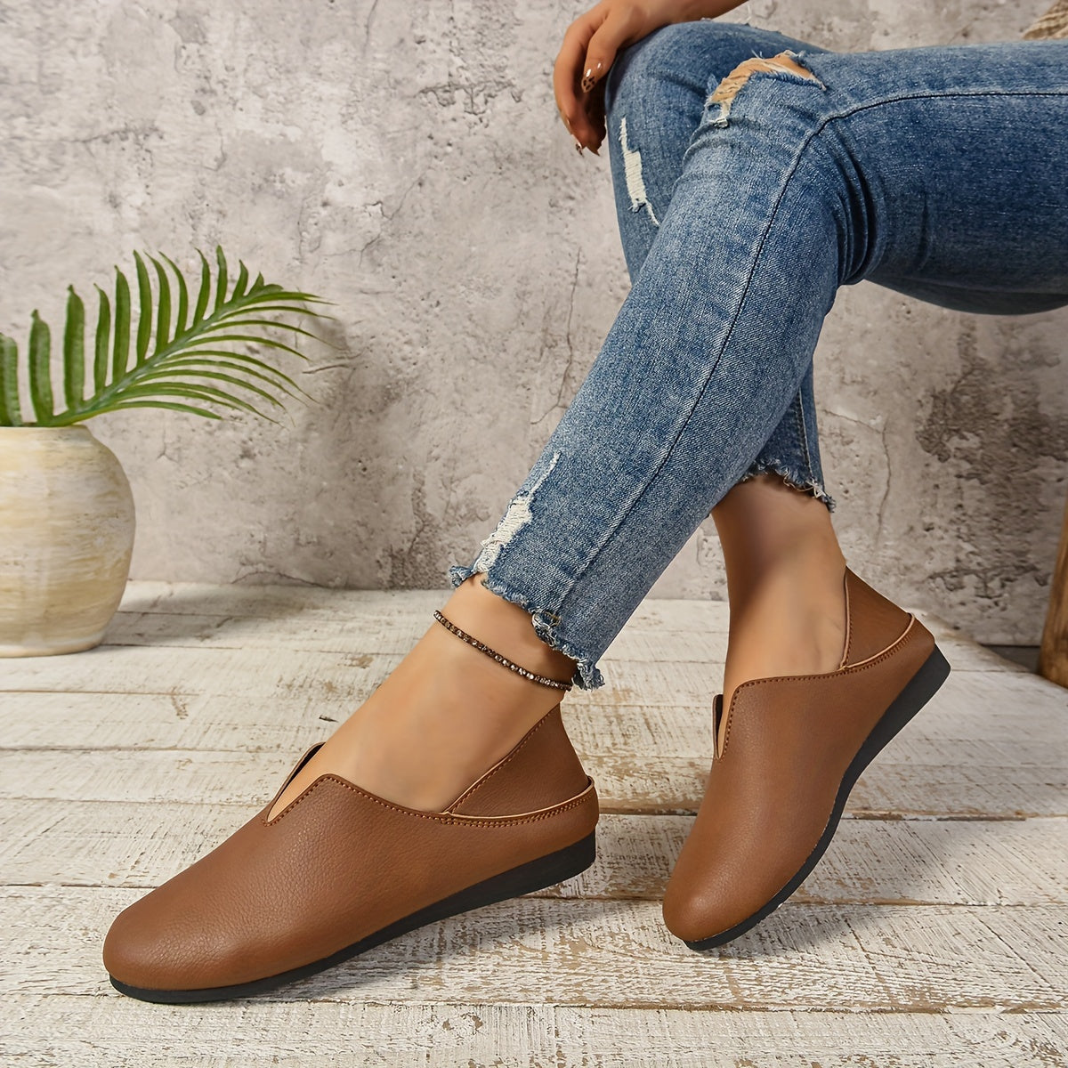 Women's slip-on loafers with round toe, solid color, faux sole, and fabric lining.