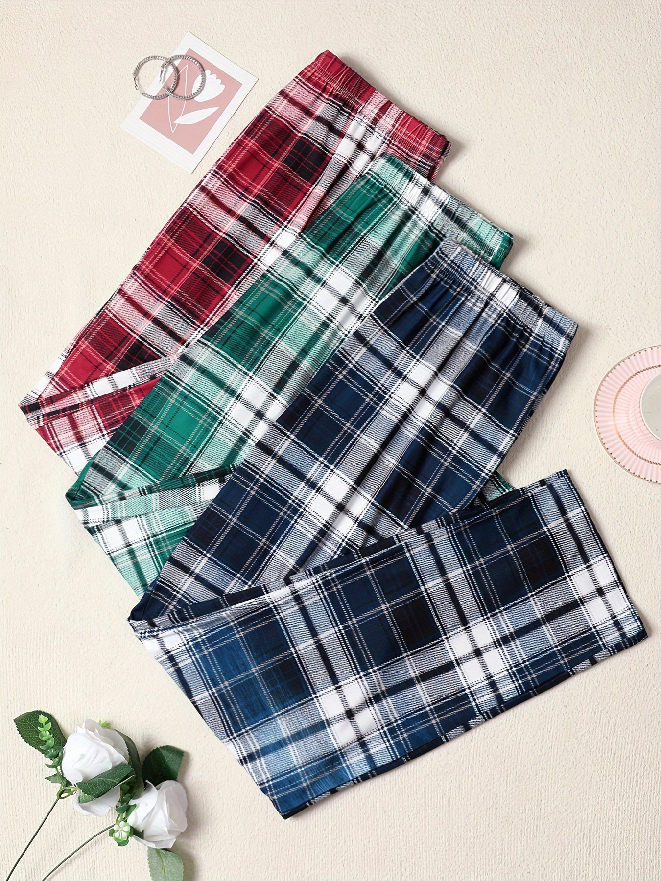 3-pack of men's plaid pajama pants with comfortable medium stretch knit fabric in assorted designs.