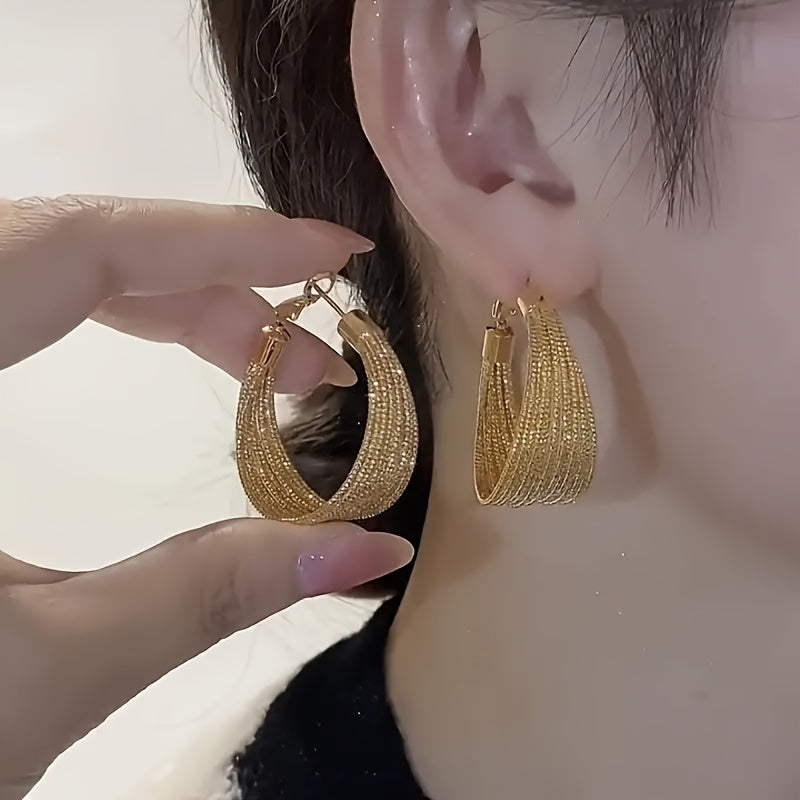 Elegant multi-layer geometric alloy hoop earrings with golden clasp. Perfect for daily wear and special events, suitable as a gift for friends. Geometric design complemented by a fabric