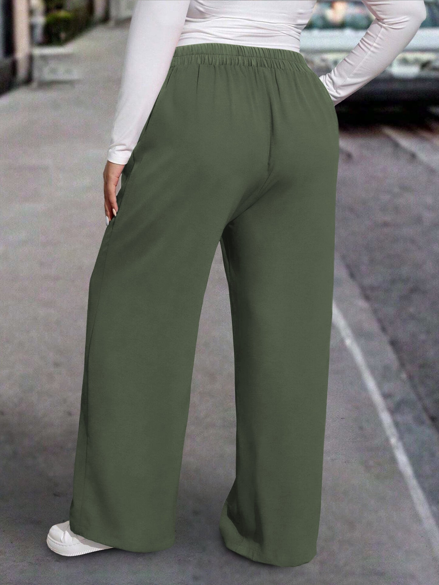 New stylish large women's pants, extended and loose fit, comfortable and light, in a sleek solid color.