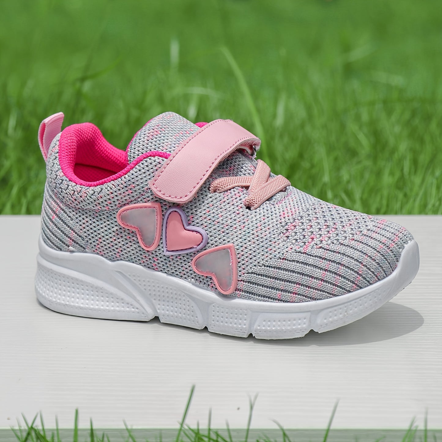 Kids' pink heart design athletic sneakers with breathable knit upper, secure hook-and-loop closure, non-slip rubber sole, perfect for running and walking all year round.