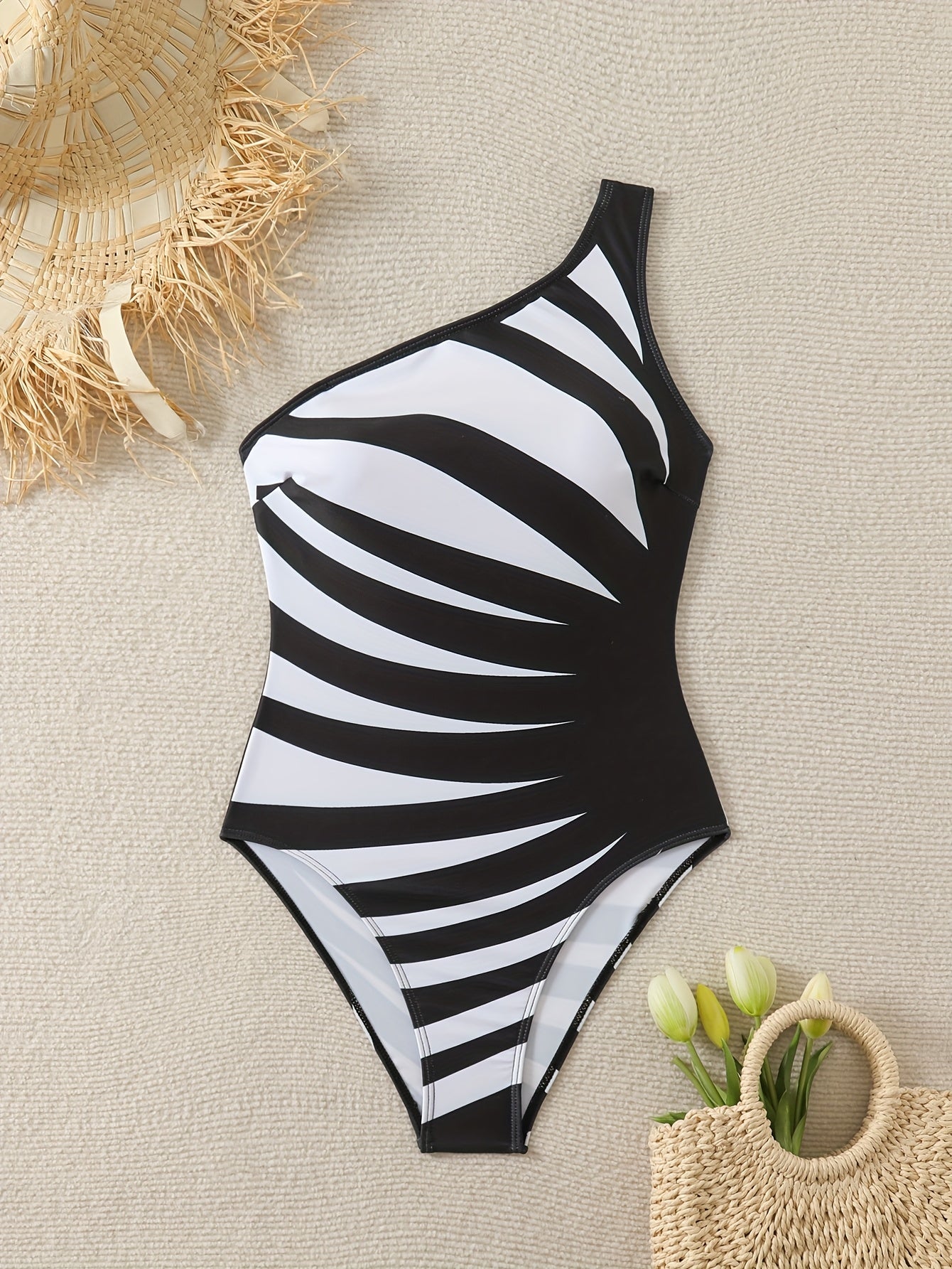 Chic one-shoulder striped bodysuit swimsuit with stretchy knit fabric, removable padding, and asymmetrical design.