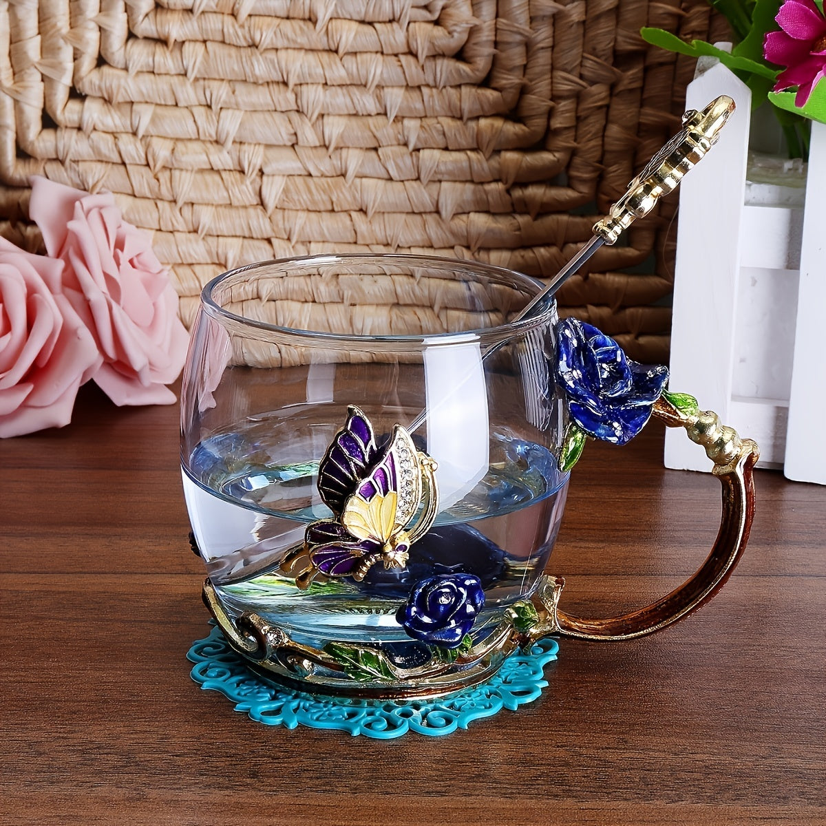 Rose enamel crystal tea cup with butterfly and rose design, includes spoon, clear glass.