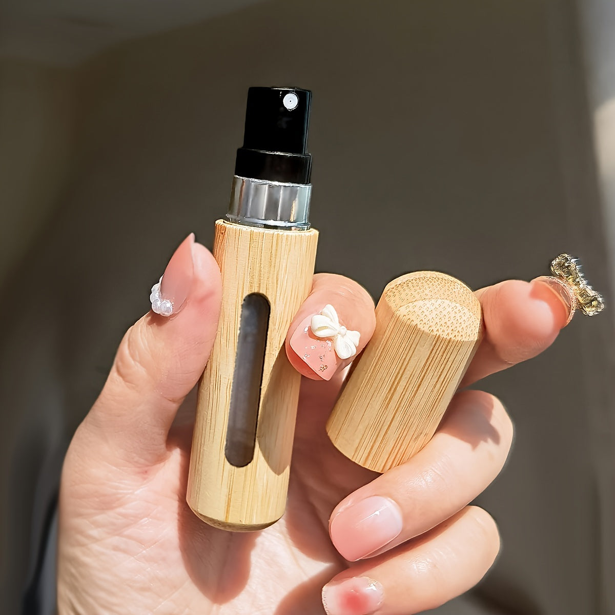 Set of bamboo shell perfume atomizers, refillable spray bottles in 5ml & 8ml sizes. Portable and luxurious fragrance dispensers with visible window, ideal for travel and outdoors.